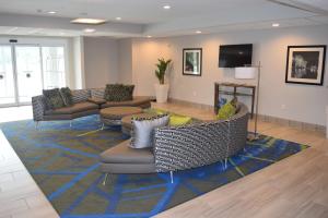 a lobby with couches and chairs on a rug at Candlewood Suites - Nashville Metro Center, an IHG Hotel in Nashville