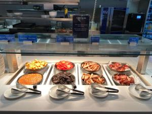 a display of different types of food on a counter at ibis Brisbane Airport in Brisbane