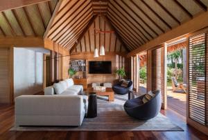 - un salon avec un canapé et une télévision dans l'établissement Four Seasons Resort Bora Bora, à Bora Bora