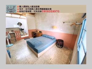 Rúm í herbergi á 屏東市鄉下人家生活體驗