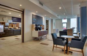 a waiting room with chairs and a table and a counter at Holiday Inn Express & Suites Mt Sterling North, an IHG Hotel in Mount Sterling