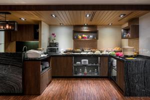 a kitchen with a counter with food on it at Park Avenue Clemenceau in Singapore