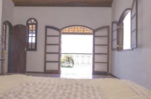 A bed or beds in a room at Casa Ilha Grande