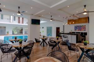 a room with tables and chairs and a pool at Riviera Sayulita Hotel in Sayulita