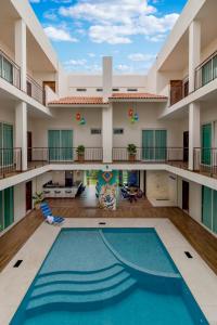 an indoor pool in an apartment building with a swimming pool at Riviera Sayulita Hotel in Sayulita