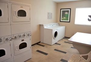 a kitchen with a white refrigerator and a white stove at Candlewood Suites Alexandria, an IHG Hotel in Alexandria