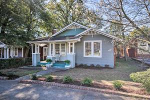 a small white house with a porch at Charming 1916 Bungalow about 3 Miles to Augusta Course in Augusta