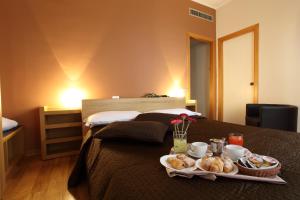 Postel nebo postele na pokoji v ubytování Hotel Del Viale
