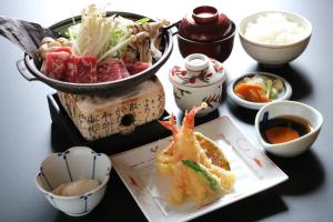 a table with a plate of food and bowls of food at Gifu Washington Hotel Plaza in Gifu +11 photos
