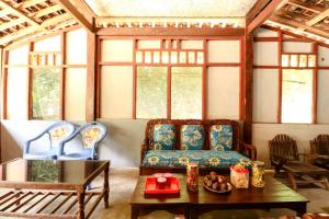 a living room with two chairs and a couch at Iran Homestay in Sermo
