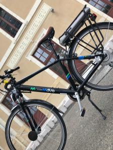 a black bike parked on the street next to a building at Gite le Petit Puits à Richelieu in Richelieu