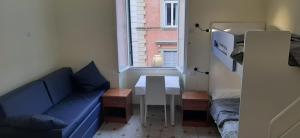 a small room with a blue couch and a table at AFFITTACAMERE ROMANSTYLE in Rome