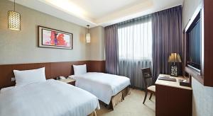 Katil atau katil-katil dalam bilik di Guanko Hotel