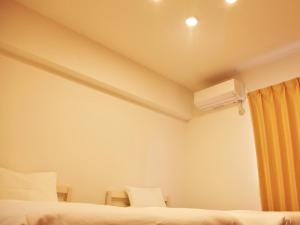 a hotel room with two beds and a air conditioner at Mango Resort Okinawa Naha in Naha