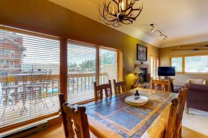 a dining room with a table and a large window at Purgatory Village #305 in Durango Mountain Resort