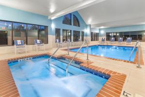 a pool in a hotel room with chairs and a swimming pool at Holiday Inn Express Hotels & Suites Greenville-Spartanburg/Duncan, an IHG Hotel in Duncan