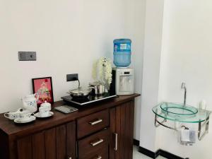 a counter with a coffee maker on top of it at Siri's Residency in Habaraduwa