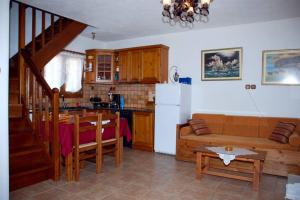 a kitchen and a living room with a couch and a table at Vila Elena 2 astoning view in Steni Vala Alonissos