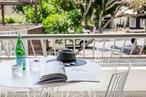 a hat and a book sitting on a table at Saks on Hastings in Noosa Heads