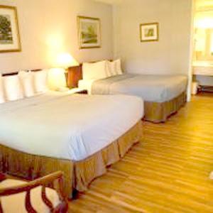 a hotel room with two beds in a room at Travelodge by Wyndham Ogallala in Ogallala