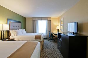 a hotel room with two beds and a flat screen tv at Holiday Inn Express Fort Saskatchewan, an IHG Hotel in Fort Saskatchewan