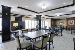a dining room with tables and chairs at Holiday Inn Express Fort Saskatchewan, an IHG Hotel in Fort Saskatchewan