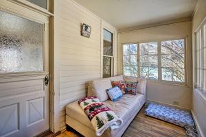 a living room with a couch and a window at Victory Victorian House - Walk to Dtwn Glenwood! in Glenwood Springs