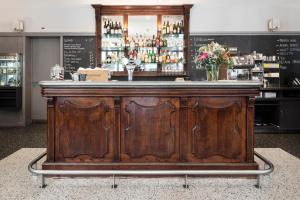 a wooden bar in a restaurant with a counter at Altstadt Hotel in Z&uuml;rich