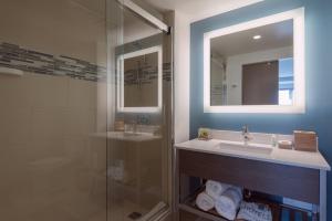 a bathroom with a sink and a glass shower at EVEN Hotel Brooklyn, an IHG Hotel in Brooklyn