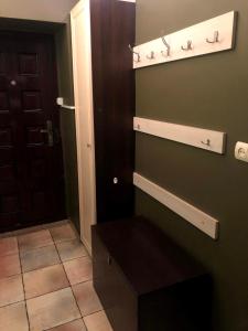 a bathroom with a bench in front of a door at GIL Apartments, Lermontova 1a, centre in Uzhhorod +2 photos