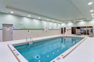 a large swimming pool in a gymnasium with at Holiday Inn Express & Suites Oshawa Downtown - Toronto Area, an IHG Hotel in Oshawa