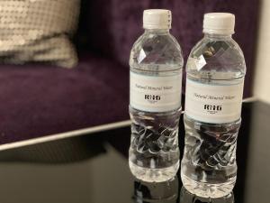 two bottles of water sitting next to each other at Hotel Trusty Osaka Abeno in Osaka