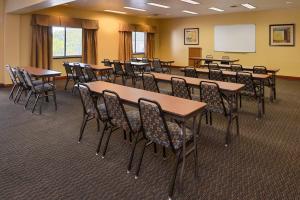 a conference room with tables and chairs and a whiteboard at Holiday Inn Express Morgantown, an IHG Hotel in Morgantown