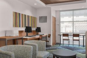 a living room filled with furniture and a large window at Holiday Inn Express Hotel & Suites Sacramento Airport Natomas, an IHG Hotel in Sacramento