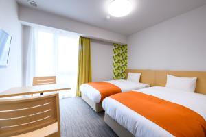 Postel nebo postele na pokoji v ubytování Hotel Sobial Namba Daikokucho