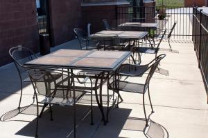 a group of tables and chairs on a patio at Holiday Inn Express & Suites Youngstown West I 80, an IHG Hotel in Austintown