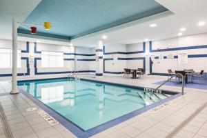 una piscina de agua azul en un edificio en Holiday Inn Express Hotel & Suites Milton, an IHG Hotel, en Milton