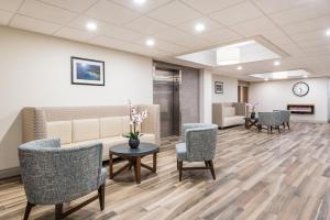 a waiting room at a hospital with chairs and a couch at Holiday Inn Express Hotel & Suites 1000 Islands - Gananoque by IHG in Gananoque +27 photos