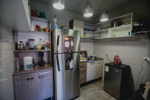 a kitchen filled with lots of clutter and appliances at Way Kap Hostel Arequipa in Arequipa
