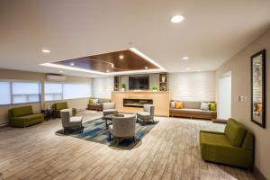 a large living room with couches and chairs at Holiday Inn Express Hotel & Suites Saint John Harbour Side, an IHG Hotel in Saint John