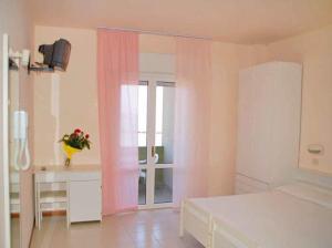 - une chambre avec un lit, une table et une fenêtre dans l'établissement Hotel Principe, à Gatteo a Mare
