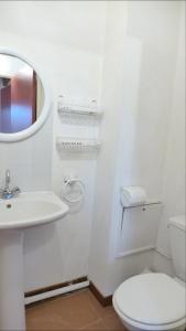 a bathroom with a toilet and a sink and a mirror at Réf 272,Seignosse océan, Villa Patio à 150m de la plage, avec place de parking et piscine commune , 4 personnes in Seignosse