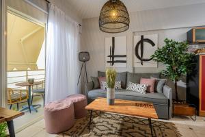 a living room with a couch and a table at Creticum Suites in Heraklio +22 photos