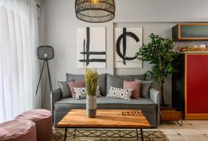 a living room with a couch and a table at Creticum Suites in Heraklio