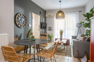 a living room with a table and chairs at Creticum Suites in Heraklio