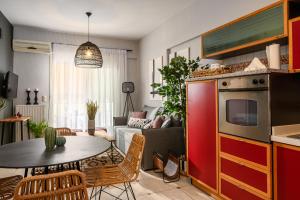 een keuken en een woonkamer met een tafel en stoelen bij Creticum Suites in Heraklion