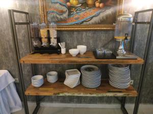 a shelf with plates and utensils on it at Basilica Guest House in Istanbul