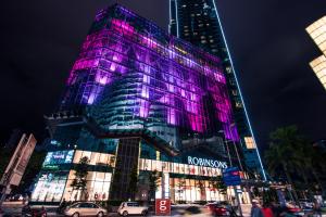 a building with purple lights on the side of it at EXPRESSIONZ KLCC BY G Suites in Kuala Lumpur