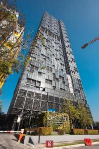 a tall building with a sign in front of it at EXPRESSIONZ KLCC BY G Suites in Kuala Lumpur