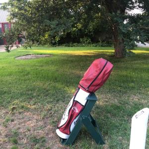 a baseball bat on a stand in the grass at Altitude221 in Mansfield